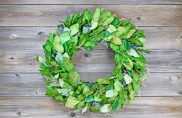 istock Seasonal green leaf wreath on rustic cedar wood 466695356