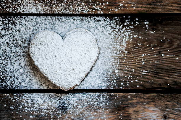istock Heart cookies with sugar powder on rustic wooden background 466702115