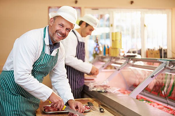 istock Two Butchers Preparing Meat In Shop 466704061