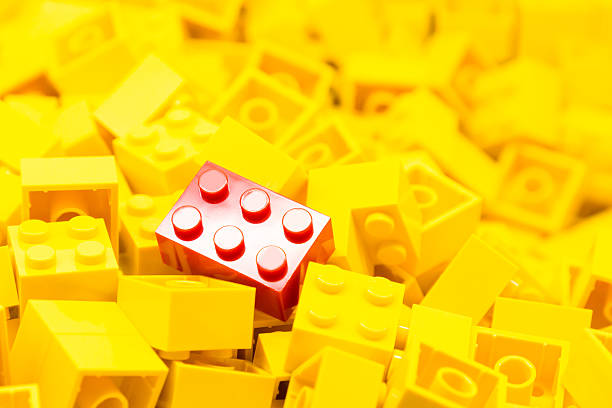istock Pile of yellow building blocks with focus on red block 466704584