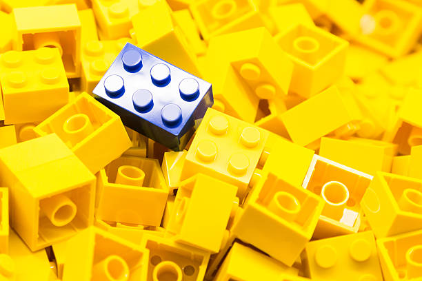 istock Pile of yellow building blocks with focus on blue block 466704596
