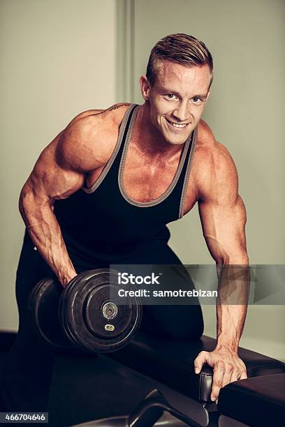 Hnadsome Young Man Working Out With Dumbbells In Fitness Stock Photo - Download Image Now