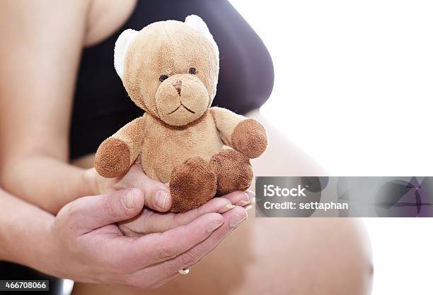 Mom And Dad Prepare Bear Doll For A New Life Stock Photo - Download Image Now - 2015, Abdomen, Adult