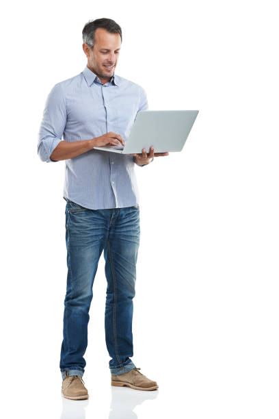 Connected wherever he goes Full length shot of a handsome man using his laptop against a white backgroundhttp://195.154.178.81/DATA/i_collage/pu/shoots/785221.jpg man laptop stock pictures, royalty-free photos & images