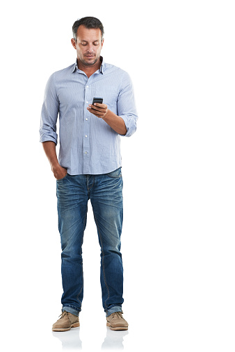 Full length shot of a handsome man checking his phone against a white backgroundhttp://195.154.178.81/DATA/istock_collage/a3/shoots/785221.jpg