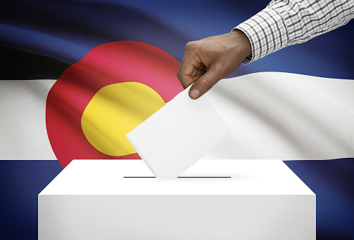 Voting concept - Ballot box with US state flag on background - Colorado