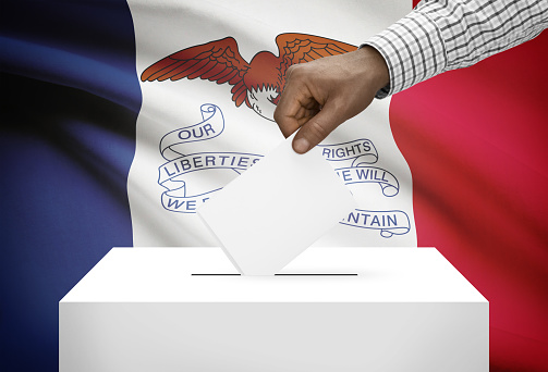 Voting concept - Ballot box with US state flag on background - Iowa