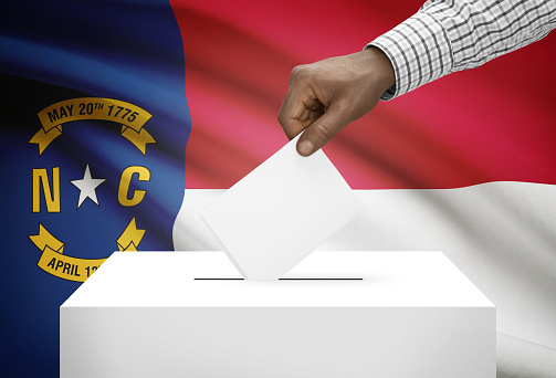 Voting concept - Ballot box with US state flag on background - North Carolina