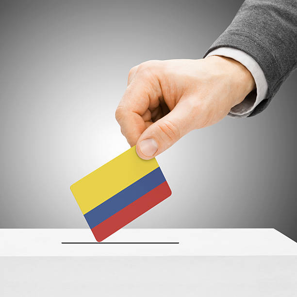 istock Voting - Male inserting flag into ballot box - Colombia 466712324
