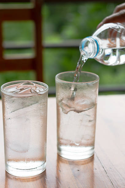 istock Glass of water on nature background 466712582