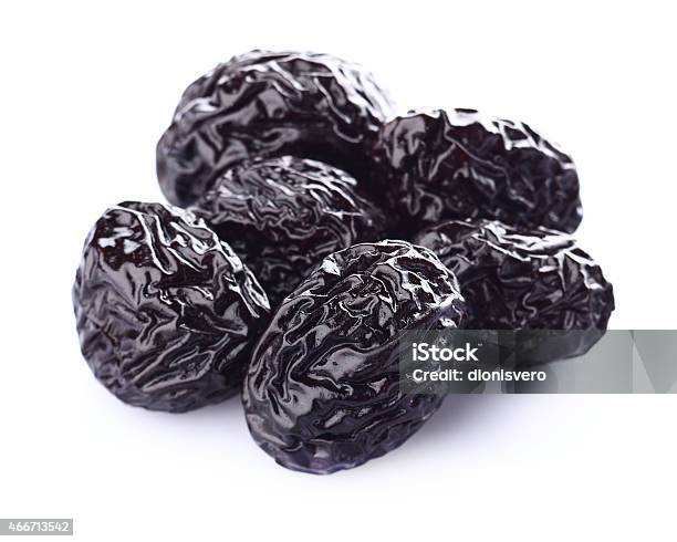 Several Dried Prunes On A White Background Stock Photo - Download Image Now - Dried Plum, Plum, Cut Out