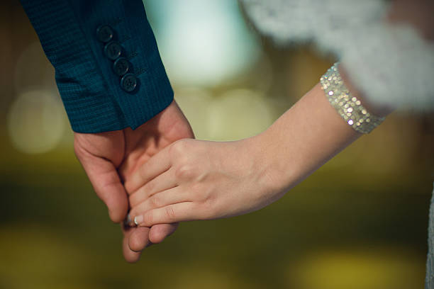 istock Just married couple holding hands outdoors 466713584