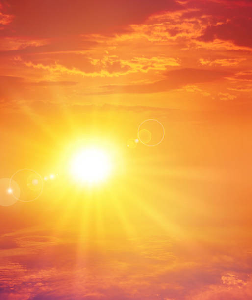 The setting sun in a cloudy sky background