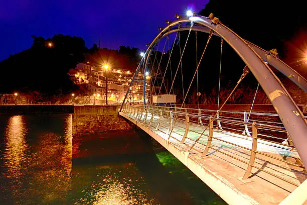 Photo of modern iron bridge overnight in Cudillero, Spain