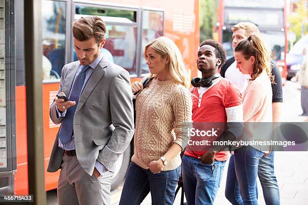 Queue Of People Waiting At Bus Stop Stock Photo - Download Image Now - Waiting In Line, Bus, Waiting