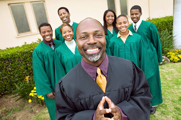 istock Preacher And Choir Standing In Front Of Church 466716325