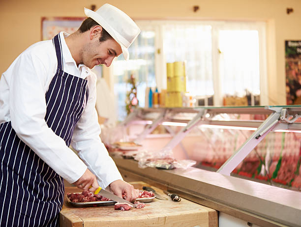 istock Butcher Preparing Meat In Shop 466716611
