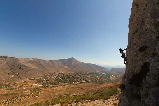 A woman rock climbing silhouette, Kalymnos, Greece.