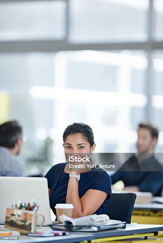 Work couldn't be better! Portrait of a designer sitting at her desk working on a laptop with colleagues in the backgroundhttp://195.154.178.81/DATA/i_collage/pi/shoots/785199.jpg Business Person Stock Photo