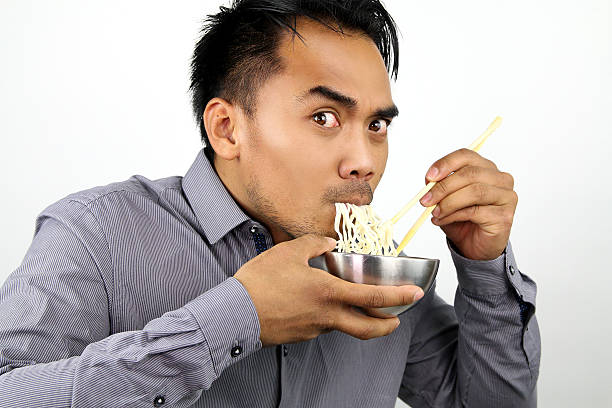 istock Asian man eating noodles 466718468