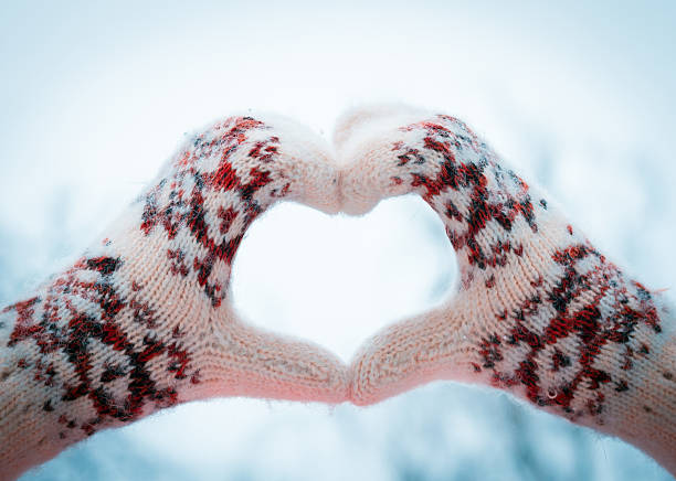 istock mittens heart on winter background 466719548