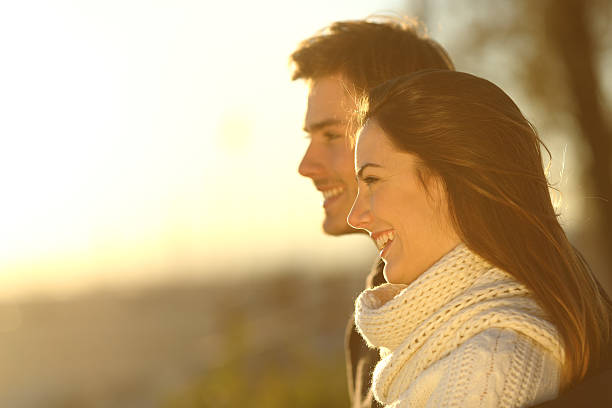 istock Happy couple looking at sunset in winter 466720068