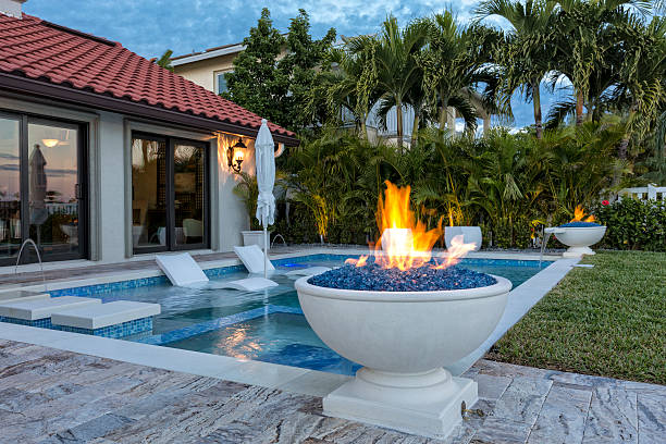 Swimming Pool Beautiful swimming pool with fire pots. building feature stock pictures, royalty-free photos & images