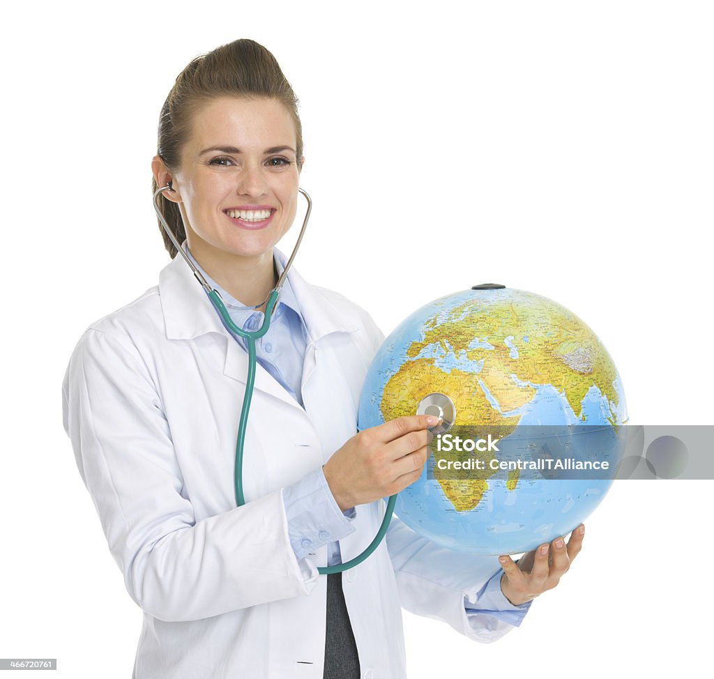 happy medical doctor woman listening globe with stethoscope Happy medical doctor woman listening globe with stethoscope Adult Stock Photo