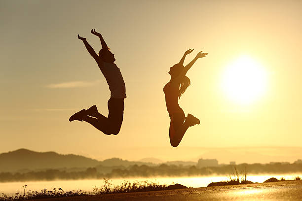istock Fitness couple jumping happy at sunset 466723048