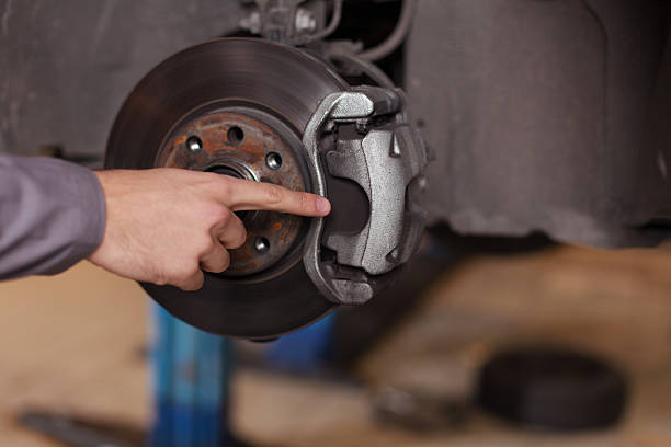 Hand pointing at car brakes Mechanic hand pointing at brake pads brake disc photos stock pictures, royalty-free photos & images