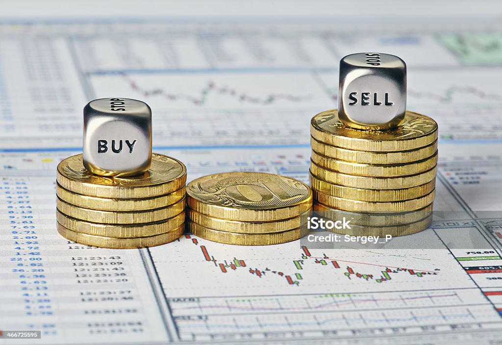 Financial chart, coins and dice cubes Financial chart, coins and dice cubes with the words Sell Buy. Selective focus Buy - Single Word Stock Photo