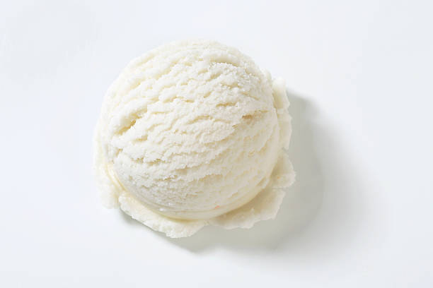 One single lemon ice cream scooped onto a plain background stock photo