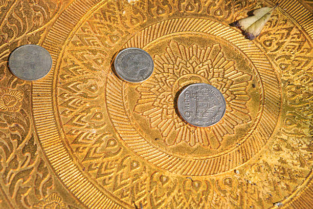istock Full frame shot of a gold colored plate with coins 466728667