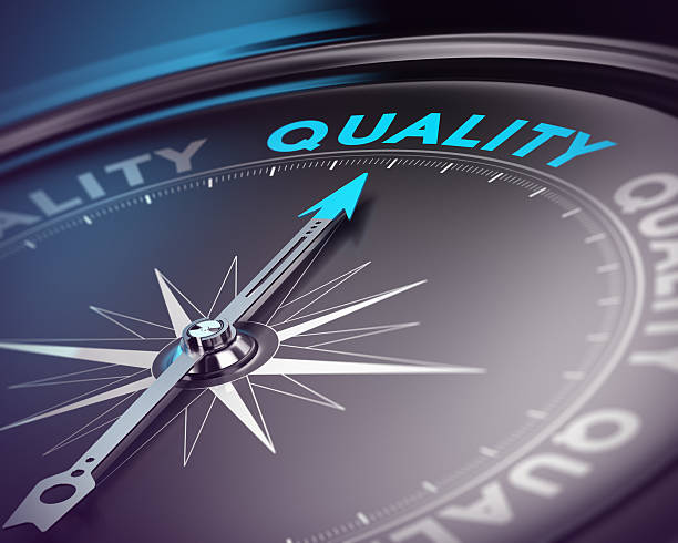 Quality Assurance Concept Compass needle pointing the blue text. Blue and black tones with blur effect and focus on the main word. Concept for quality assurance management. quality stock pictures, royalty-free photos & images