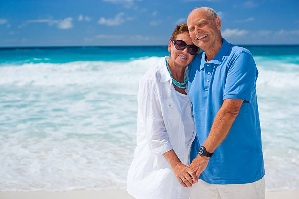istock happy senior couple holding hands on the beach 466729293
