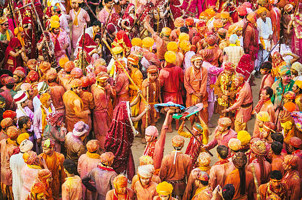 Holi Festival celebration, Barsana, Rajasthan, India crowd of villagers celebrate Holi , women beat men with sticks indian music stock pictures, royalty-free photos & images