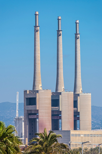 Three chimneys of a thermal power plant closed in Barcelona, Catalonia, Spain