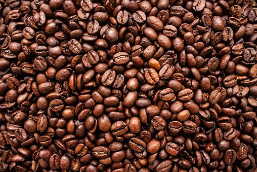 View of  fresh coffee beans over table in the kitchen at home.