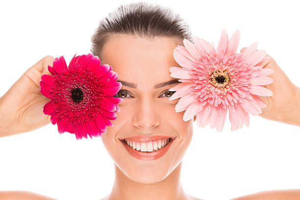 istock Smiling young woman holding flowers 466734450