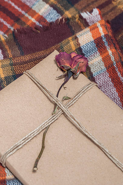 istock Present wrapped, decorated with a flower, on a wool blanket 466736418