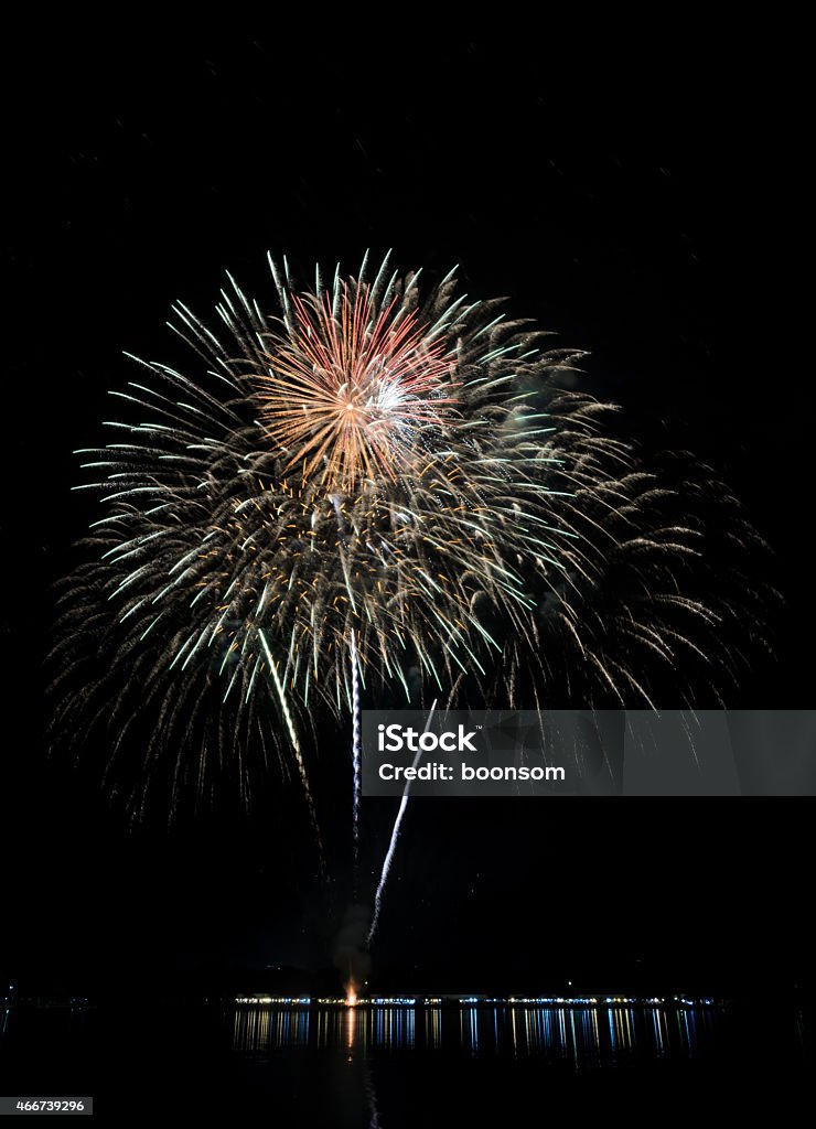 Colorful fireworks with reflection on lake Colorful fireworks exploding with reflection on lake 2015 Stock Photo