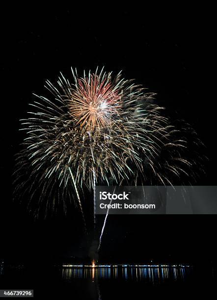 Colorful Fireworks With Reflection On Lake Stock Photo - Download Image Now - 2015, Black Color, Exploding
