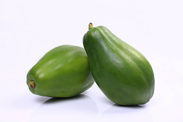 Green papaya Green papaya on white background papaya stock pictures, royalty-free photos & images