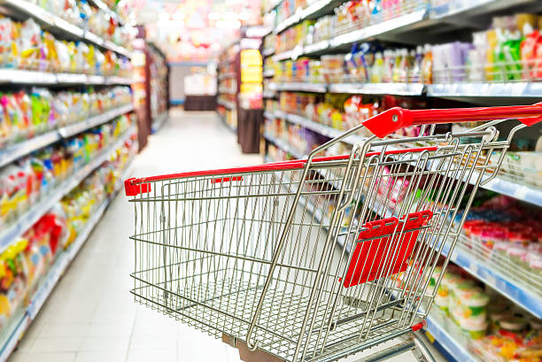 istock Supermarket interior, empty red shopping cart. 466742189