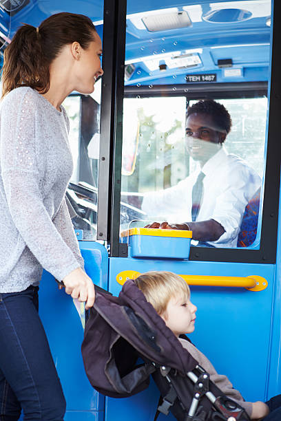 istock Mother With Child In Pushchair Boarding Bus 466742297