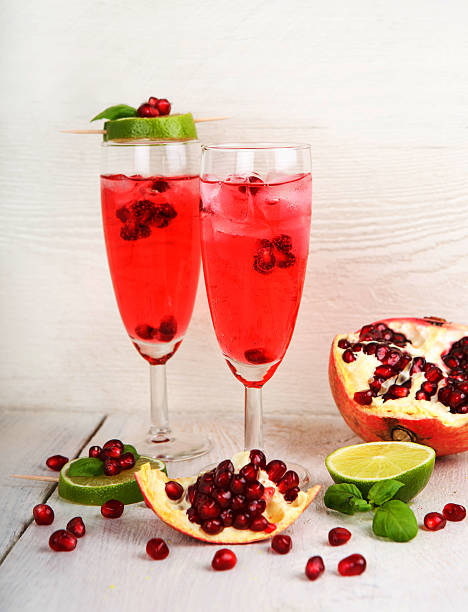 istock Two glasses with red pomgranate champagne, lime and mint. 466742521