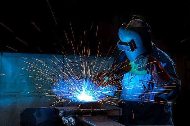 Close-up of a welder wielding sparks Arc welder with welding sparks blue sparks stock pictures, royalty-free photos & images