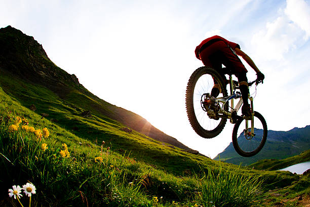 Low angle view mountain bike cyclist cycling on the hill mountain with clear sky on top of a mountain . Extreme sport concept.