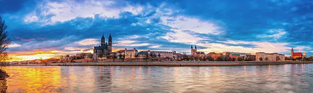 Panoramic view over the river Elbe on the skyline of Magdeburg with a dramatic sunset on a beautiful winter day.