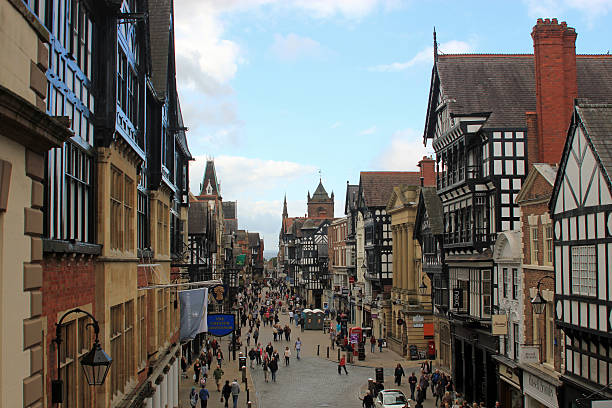 Crowded Chester City center attracting lots of visitors View of Chester City Centre showing the Tudor buildings and quaint main shopping street chester england stock pictures, royalty-free photos & images